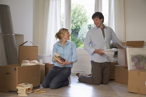 Mover carrying furniture near Hounslow flats and apartment blocks