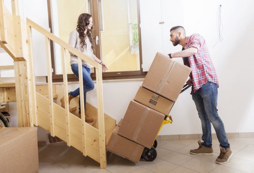 Local movers loading furniture for a relocation in West London